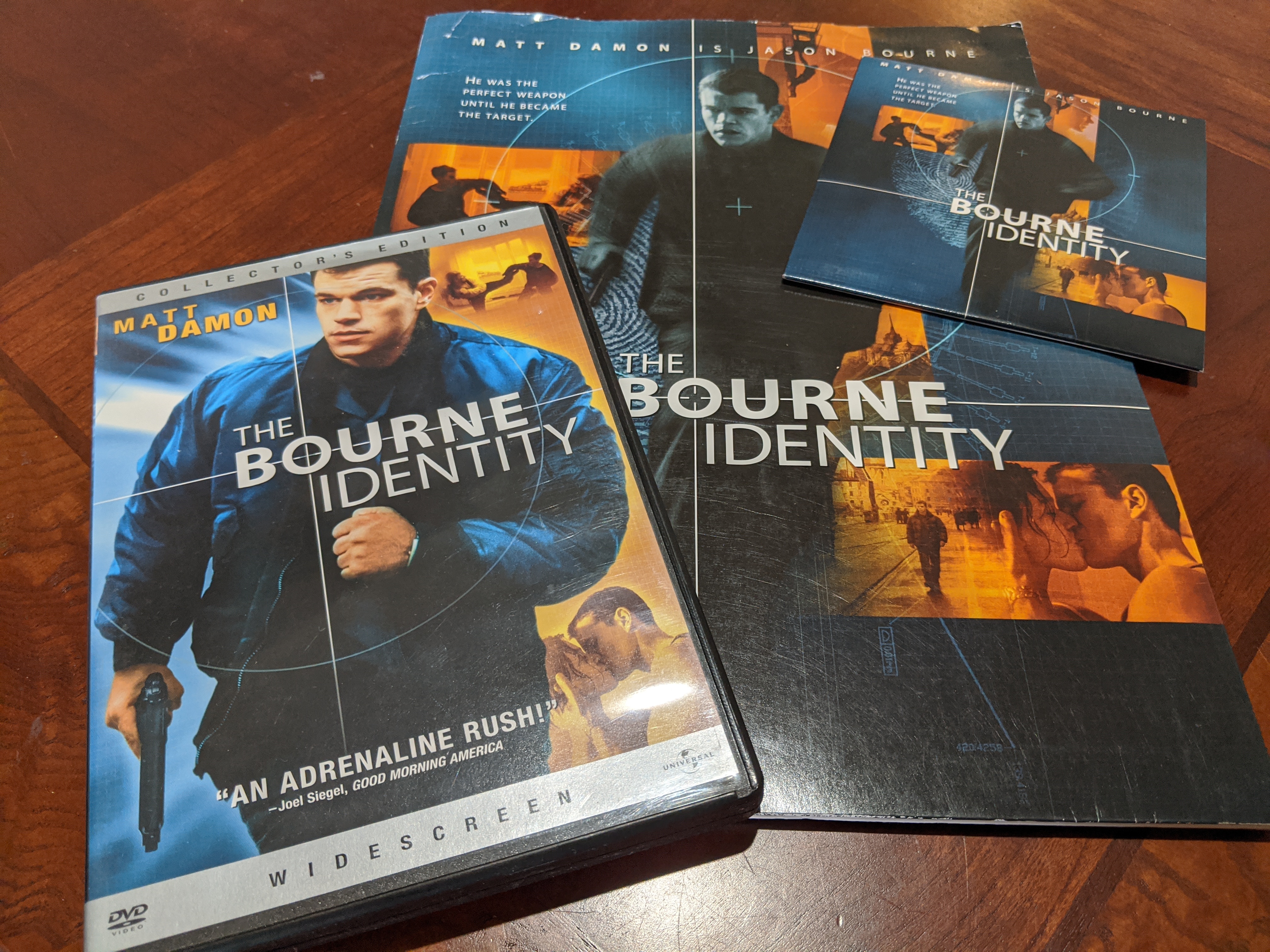 Photo of The Bourne Identity DVD next to a folder/CD that comprise a media press kit for reviewers.